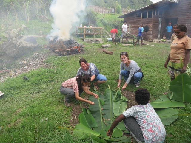 While the rocks were heating, Myriam, Narelle and I helped the women line the pit with banana leaves.
